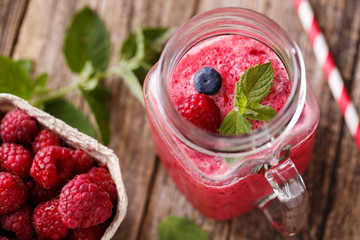 Top view on healthy berry smoothie in glass jar.