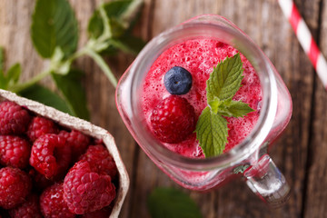 Top view on healthy berry smoothie in glass jar.