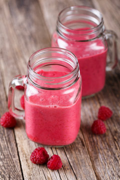 Tasty raspberry smoothie on table.