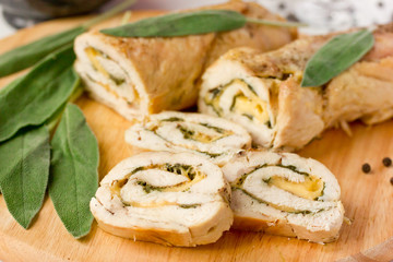 Stuffed roll of chicken with cheese and sage