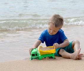 little boy playing with beach