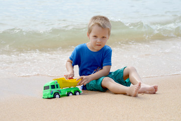 little boy playing with beach