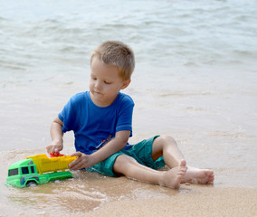 little boy playing with beach