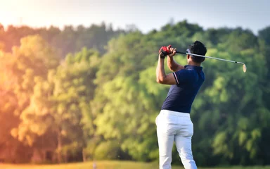 Foto auf Acrylglas Golfer hitting golf shot with club on course vintage color tone © chayathon2000