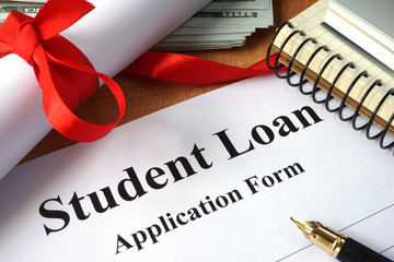 Student loan form on a wooden table.