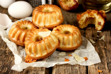 Savory cheese and bacon muffins on old wooden table