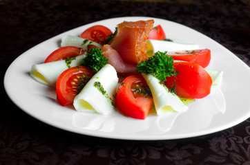Mozzarella and tomatoes with pesto on a plate