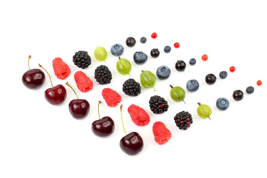 many different juicy berries are arranged in order on a white ba