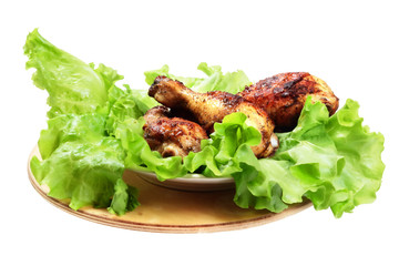 Bright delicious, grilled chicken legs with vegetables on white background.
