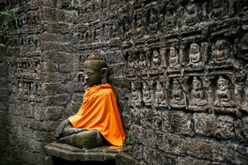 Ancient Buddha statue in orange cover