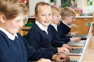 Group Of Elementary School Children In Computer Class