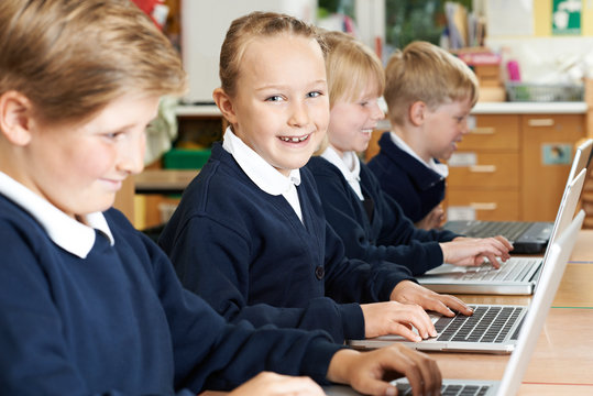 Group Of Elementary School Children In Computer Class