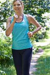 Mature Woman Running Outdoors In Countryside