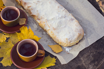 Strudel with apples, pumpkin, apricots, lemon. Autumn table decoration