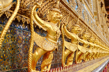 golden statue under golden pagoda in wat pra keaw , Bangkok , Th