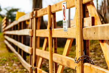 Wooden field gate closed with chain and 
