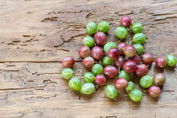 Gooseberries fresh berries on wooden background top view.