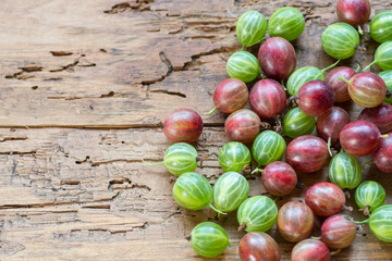 Gooseberries fresh berries on wooden background top view.