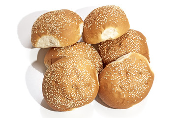 Stack of Six Golden Bread Rolls Sprinkled with Sesame Seeds
