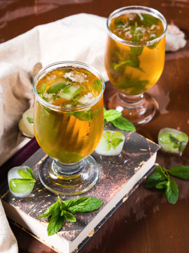 Cold tea drink with ice and mint leaves