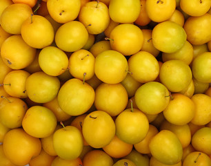 Background of fresh yellow plums close up