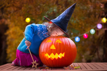 Kids carving pumpkin at Halloween