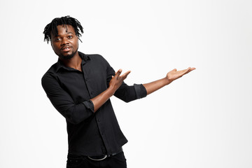 Successful african businessman pointing hands in side over white background.