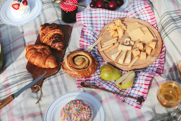 summer picnic on the rug. Fruits, berries, pastries and cheese