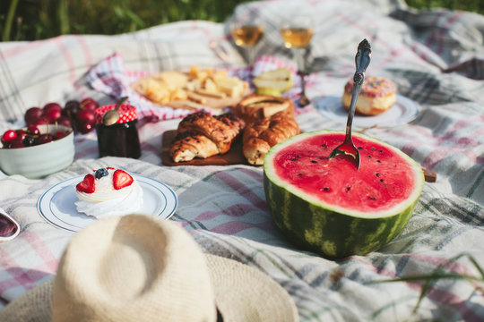summer picnic on the rug. Fruits, berries, pastries and cheese