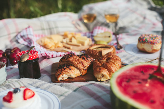 summer picnic on the rug. Fruits, berries, pastries and cheese