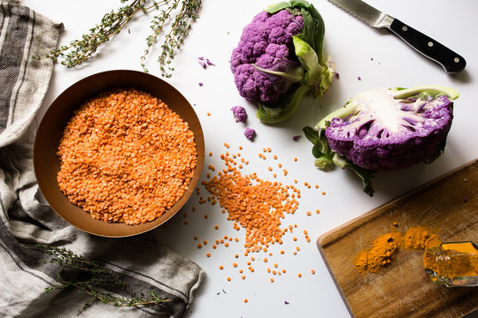 Purple cauliflower with orange seeds on worktop