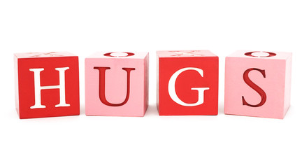 Isolated, pink and red wood blocks with word the hugs.