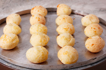Brazilian snack cheese bread (pao de queijo) on oven-tray