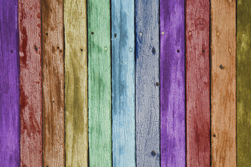 Fototapeta premium Rainbow color painted aged weathered wooden planks background.
