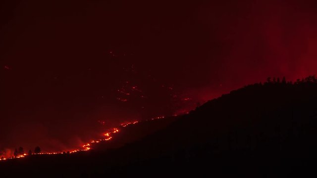 Forest fire burning a mountainside in California.