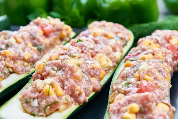 Raw courgettes stuffed with meat and vegetables