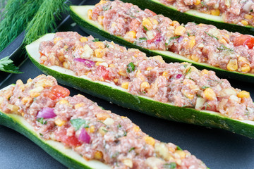 Raw courgettes stuffed with meat and vegetables