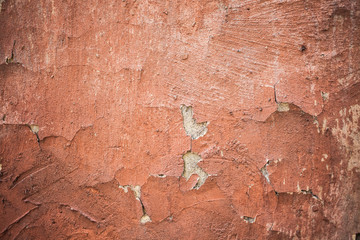 Old wall covered with paint plaster cracks