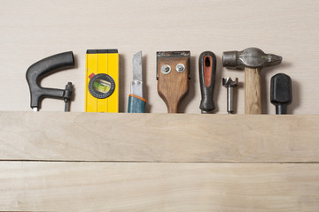 Construction tools on wooden table with sawdust. Joiner carpenter workplace top view. Copy space...