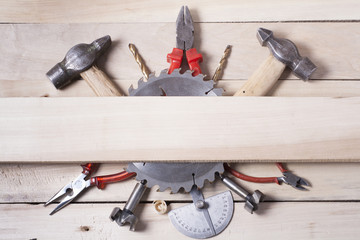 Construction tools on wooden table with sawdust. Joiner carpenter workplace top view.