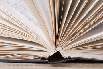 Open book, hardback books on wooden table. Education background. Back to school. Copy space for text.