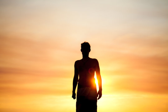 Silhouette man in summer sunset