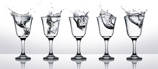Water splash in glasses isolated on gradient background