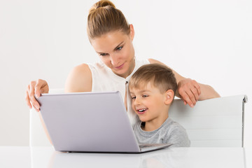 Fototapeta na wymiar Mother And Son Using Laptop