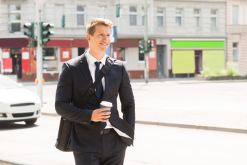 Young Businessman Walking On Street