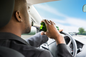 Businessman Drinking Beer While Driving Car