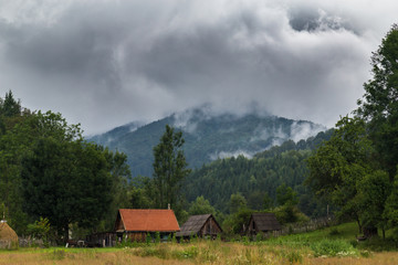 Mountain scenery in the Transylvanian Alps in summer, with mist clouds