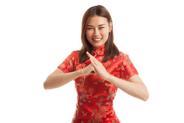 Asian girl in chinese cheongsam dress with gesture of congratula