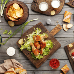 Fried chicken legs with sauce, chips and lager