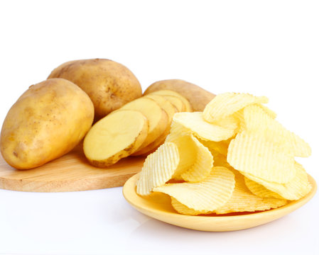 Potato chips on wooden plate on white